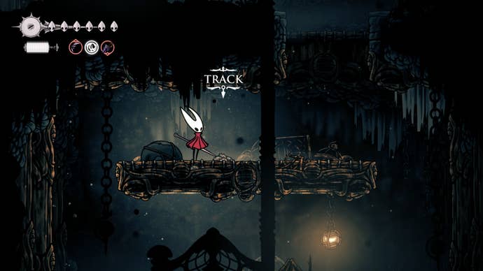 Hornet stands beside the trail leading to the Wailing Mother - the Broodmother - in Hollow Knight: Silksong