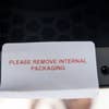 Closeup of sticker to remove internal packaging of Wired2Fire Mini PC